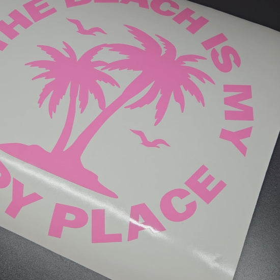 The beach is my happy place sticker in pink with palm trees and birds.