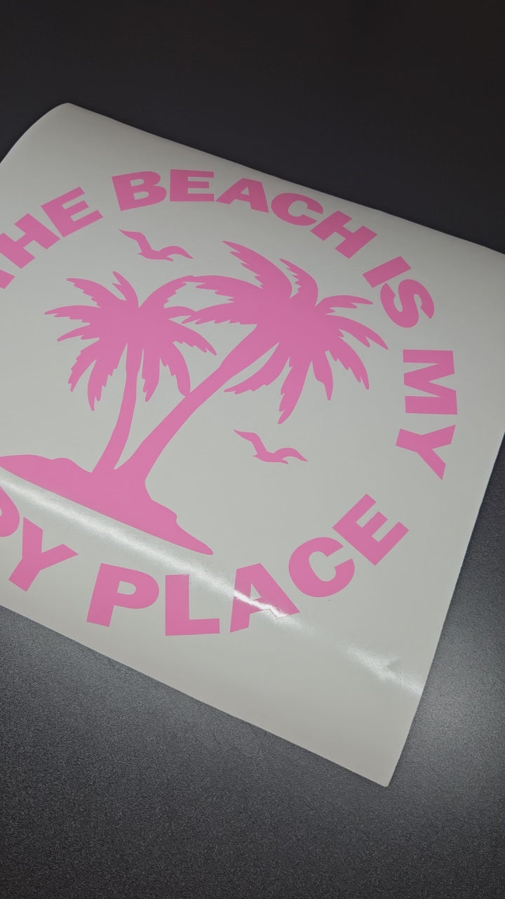 The beach is my happy place sticker in pink with palm trees and birds.